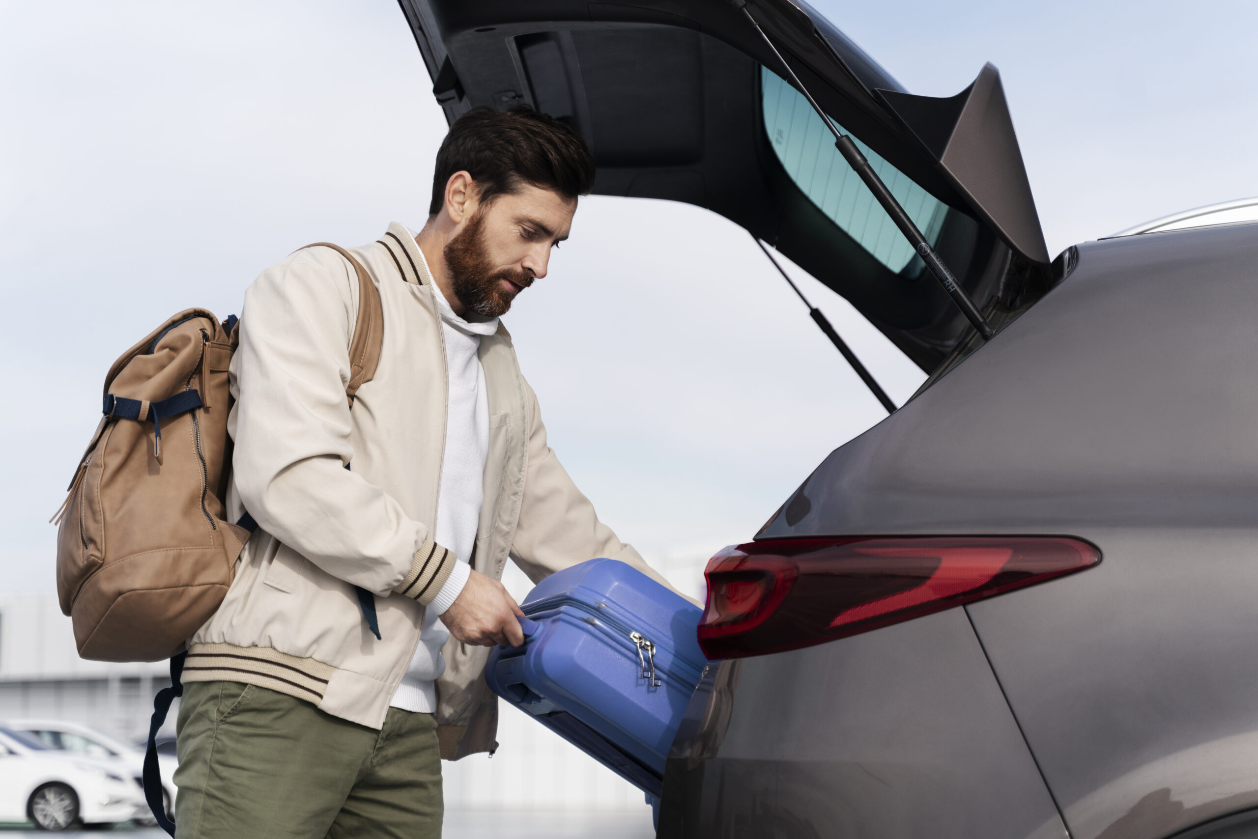 medium-shot-man-holding-blue-baggage